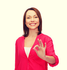 Image showing woman in casual clothes showing ok gesture