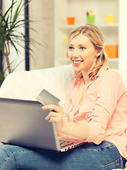 Image showing happy woman with laptop computer and credit card