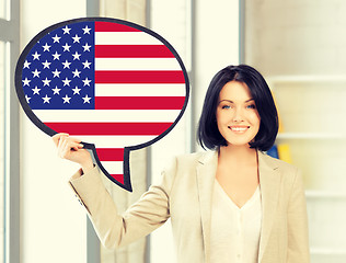 Image showing smiling woman with text bubble of american flag