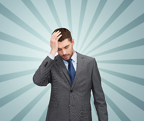 Image showing young businessman having headache