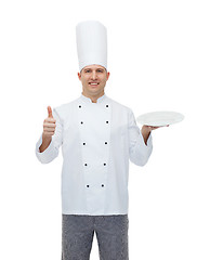 Image showing happy male chef cook showing thumbs up and plate