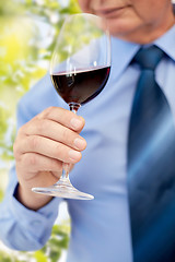 Image showing close up of senior man drinking wine from glass