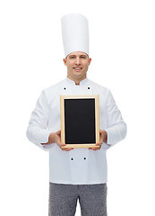 Image showing happy male chef cook holding blank menu board