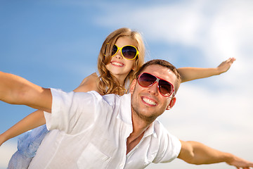 Image showing happy father and child in sunglasses over blue sky