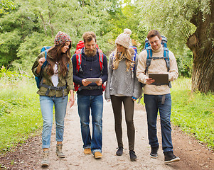 Image showing group of friends with backpacks and tablet pc