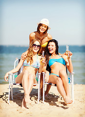 Image showing girls with drinks on the beach chairs