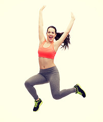 Image showing sporty teenage girl jumping in sportswear