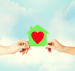 Image showing couple hands holding green paper house