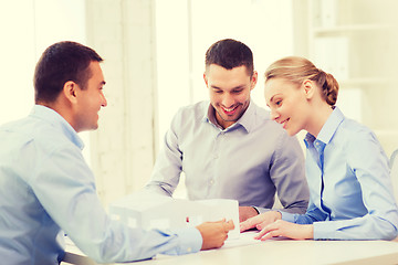 Image showing couple looking at model of their house at office