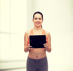 Image showing sporty woman with tablet pc blank screen