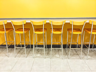 Image showing Raw of yellow chairs in a cafeteria