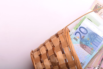 Image showing european money on wooden basket, dollars, euro