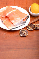 Image showing Slice of red fish salmon with fruits and cinnamon