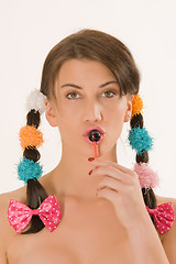 Image showing Girl with braids and colorful lollipops