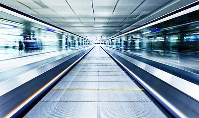 Image showing symmetric moving blue escalator inside contemporary airport