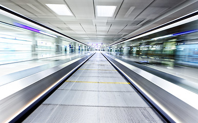 Image showing symmetric moving blue escalator inside contemporary airport