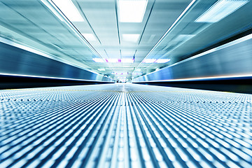 Image showing symmetric moving blue escalator inside contemporary airport