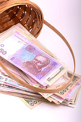 Image showing money set in a basket, dollars, euro and ukrainian money