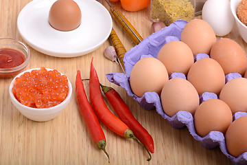Image showing eggs on eggshell and red pepper, red caviar and tomato