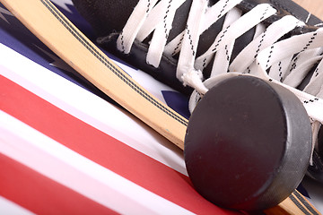 Image showing Puck, skates and hockey stick of the American flag