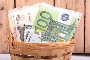 Image showing money set in a basket, dollars, euro and russian money