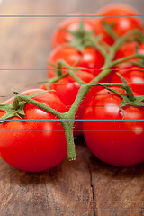 Image showing fresh cherry tomatoes on a cluster