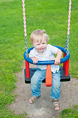 Image showing Cute baby boy playing on swing 