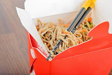Image showing Meat and noodles in red take away container