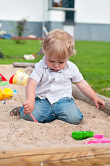 Image showing Child playing on playground in sandbox