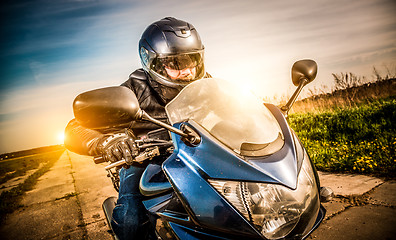 Image showing Biker racing on the road