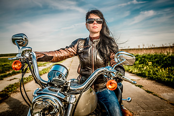 Image showing Biker girl on a motorcycle