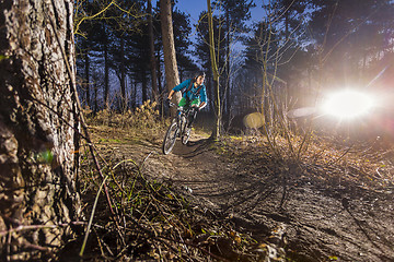 Image showing Mountainbiker through an off road trail