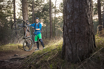 Image showing Offroad Mountain biker proud of his bike