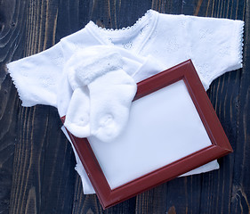 Image showing baby clothes on a table