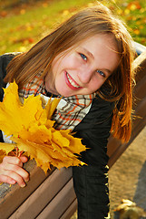 Image showing Girl with maple leaves