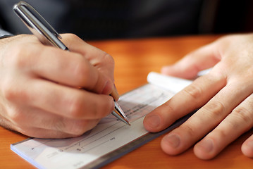 Image showing Man writing a check