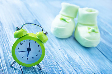 Image showing clock and baby socks