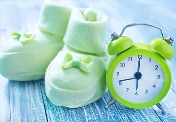 Image showing clock and baby socks