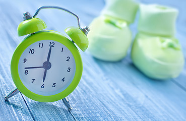 Image showing clock and baby socks