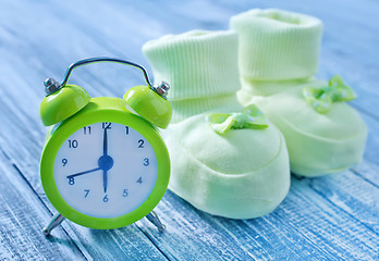 Image showing clock and baby socks