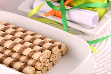 Image showing sweet cake on white plate with ribbons