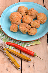 Image showing meat chop on blue plate with red pepper