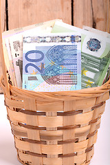 Image showing money set in a basket, dollars, euro and ukrainian money