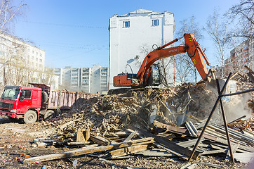 Image showing Excavator loads garbage from demolished house