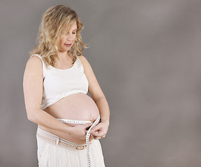 Image showing pregnant woman with measuring tape