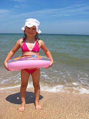 Image showing little girl with inflatable circle at the sea