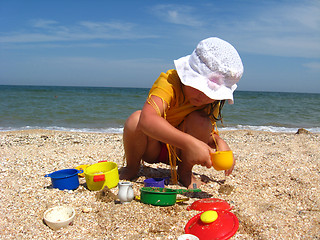 Image showing little girl plays at the sea