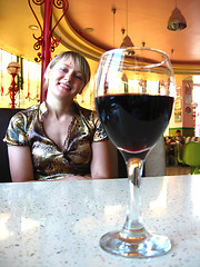 Image showing girl with glass of red wine in restaurant