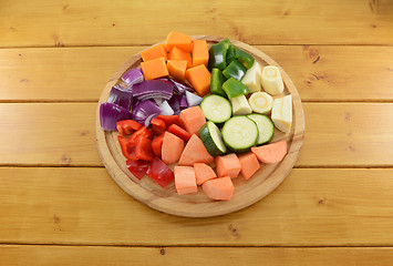 Image showing Selection of chopped vegetables on a wooden chopping board