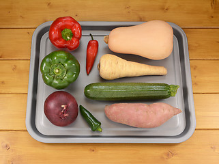 Image showing Selection of vegetables on a baking tray ready for roasting